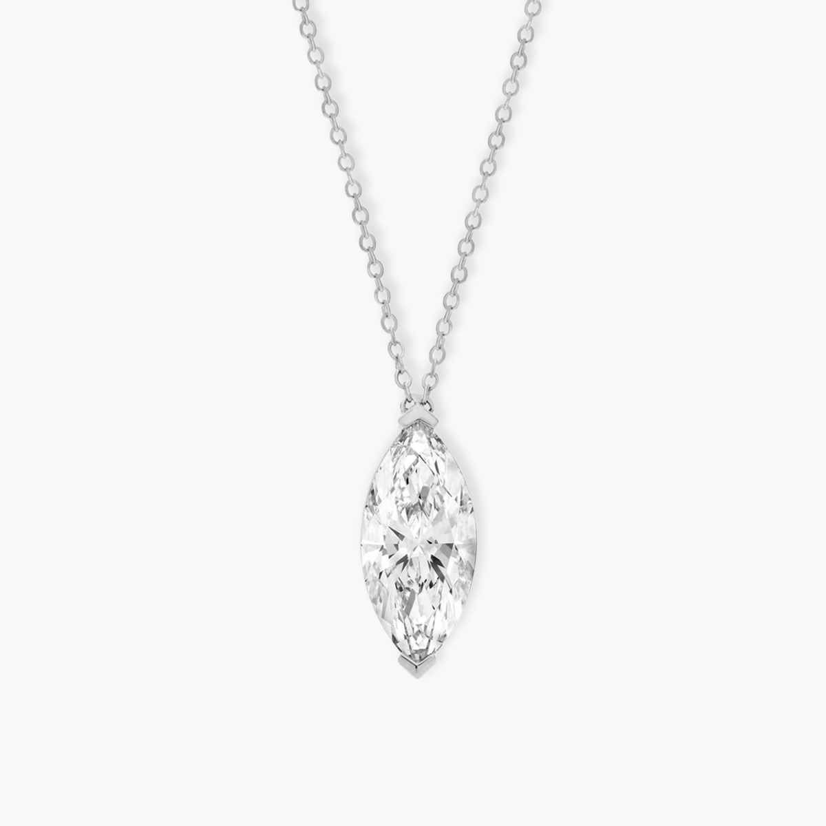 Close-up detail of a 0.5ct vertical marquise diamond pendant. The image highlights the polished White gold V-prongs that seamlessly protect the pointed ends of the gemstone.