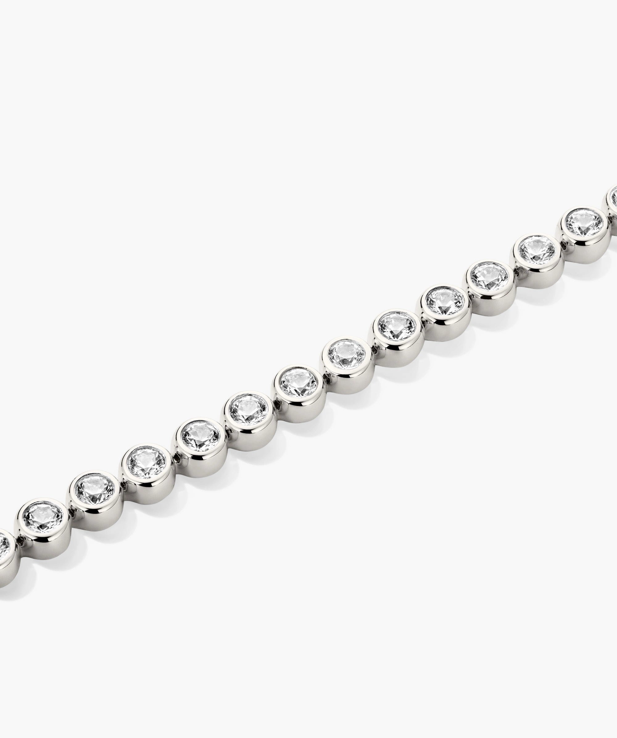 Silver bracelet with clear diamond on a white background