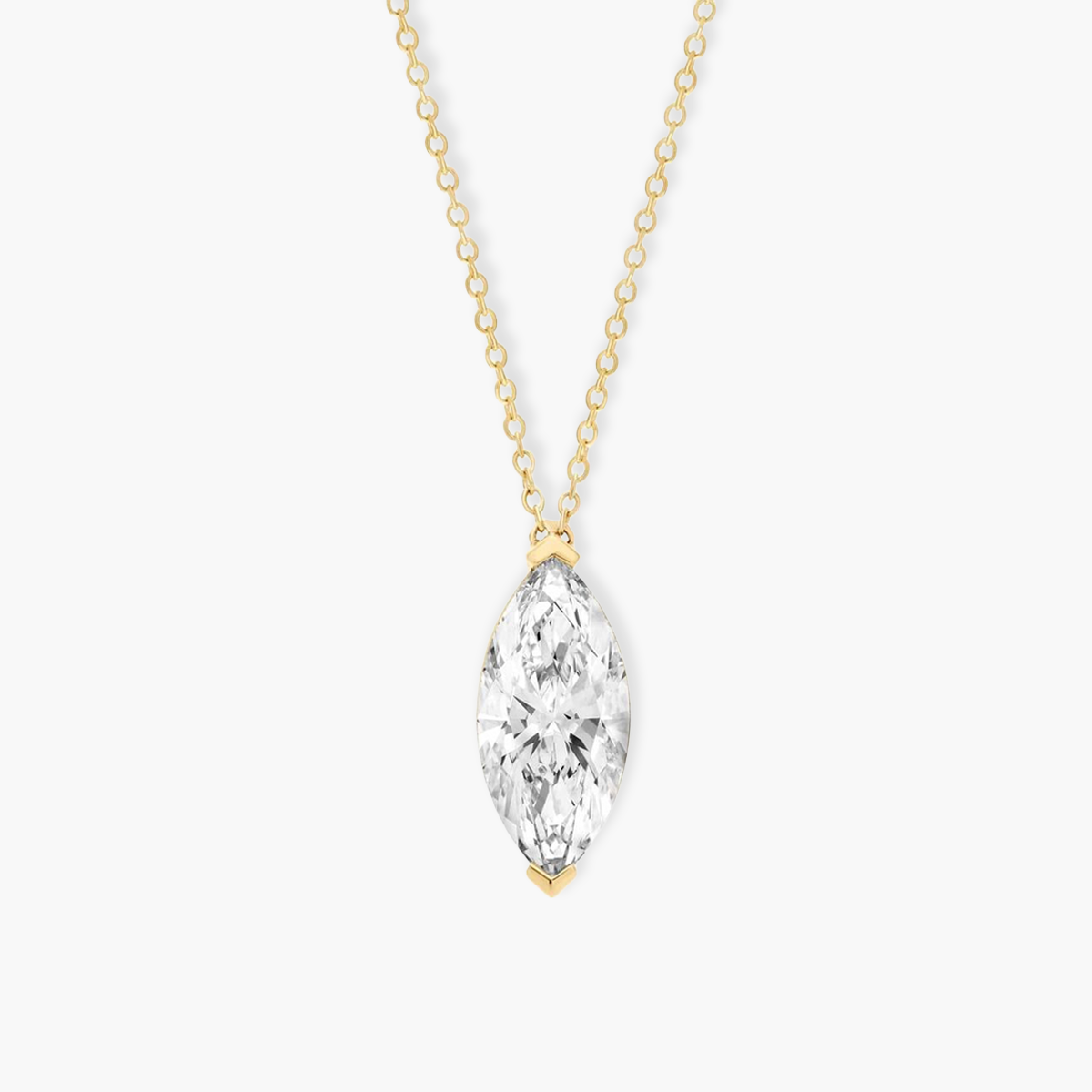 Close-up detail of a 0.5ct vertical marquise diamond pendant. The image highlights the polished 18k yellow gold V-prongs that seamlessly protect the pointed ends of the gemstone.