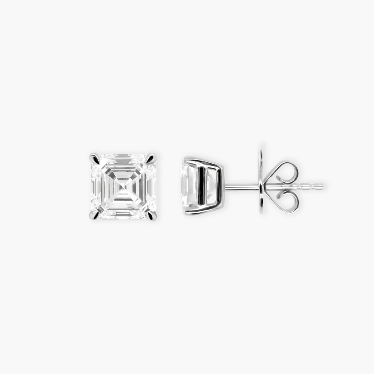 Close-up detail of an Asscher cut diamond stud earring. The macro shot highlights the geometric 'hall of mirrors' step-cut facets and the sleek white gold four-prong basket setting.