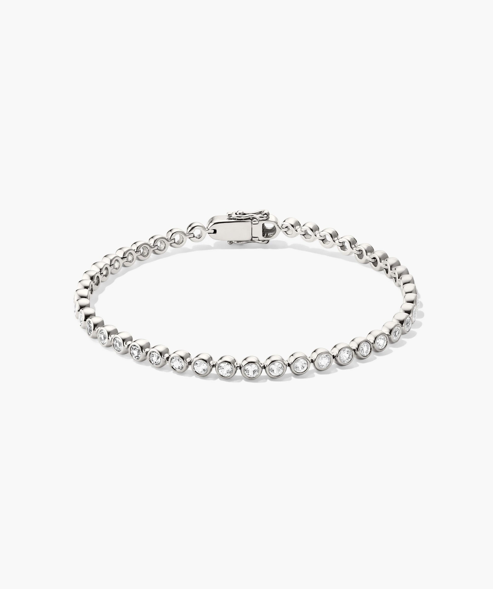Silver bracelet with clear stones on a white background